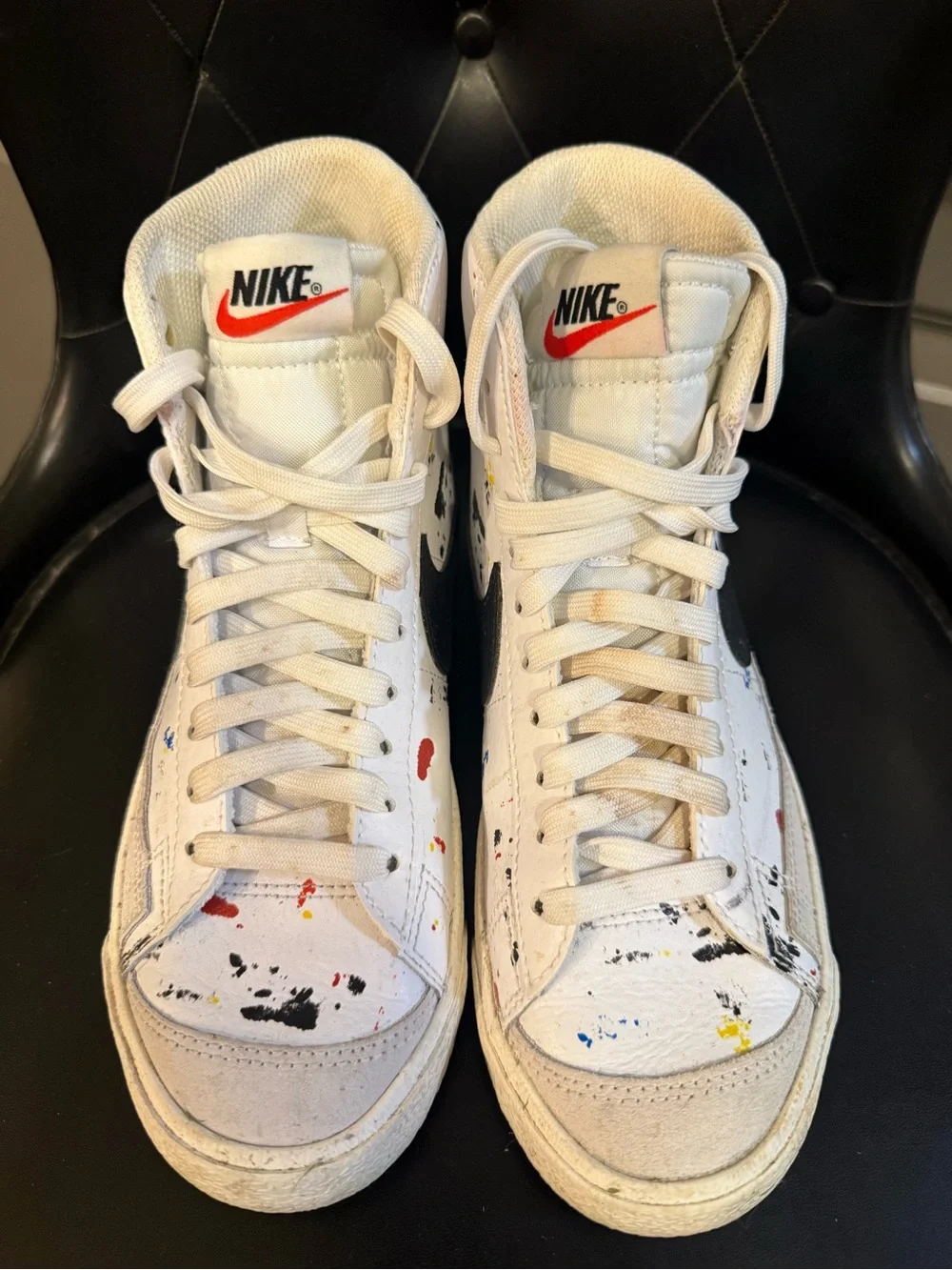 Nike White High-Top Sneakers with Black Swoosh and Paint Splatter
